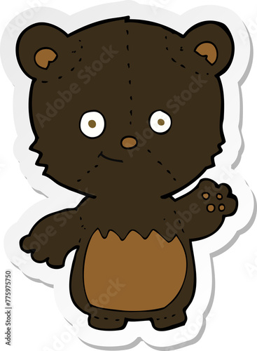 sticker of a cartoon black bearcub waving photo