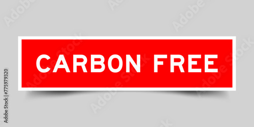 Red color square shape sticker label with word carbon free on gray background