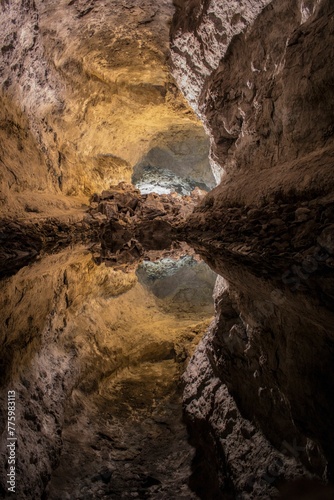 Vertical shot of Mirror-like reflection in an underground lake in the Cave of the Greens, Lanzarote