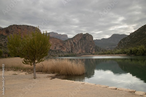 Shore of a river with mountains in the background, Sant Llorenc del Munt, Catalonia, Spain photo