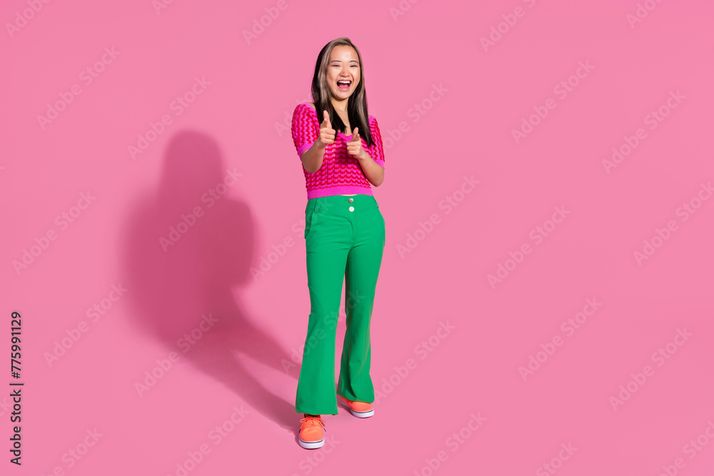 Full length photo of cool cheerful lady dressed knitted shirt pointing fingers you isolated pink color background Full length photo of cool cheerful lady dressed knitted shirt pointing fingers you isolated pink color background