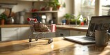Early Morning Shopping Concept with Coffee Cup Shopping Cart and Laptop on Kitchen Table
