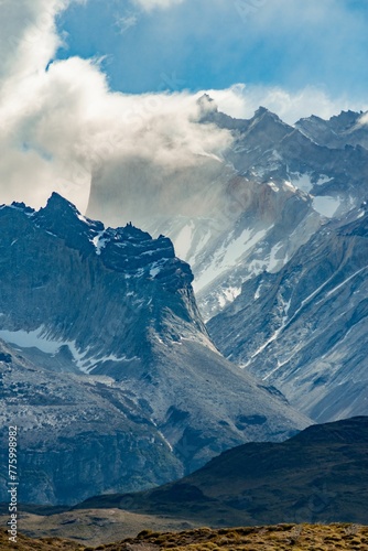 Vertical closeup of the top of the Mountains of Torres del Paine range on a cloudy day