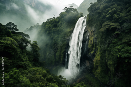 A majestic waterfall cascading down a lush green mountainside, surrounded by vibrant foliage and misty air