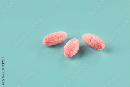 Foto Closeup shot of three pieces of medicine in the form of pink caplets