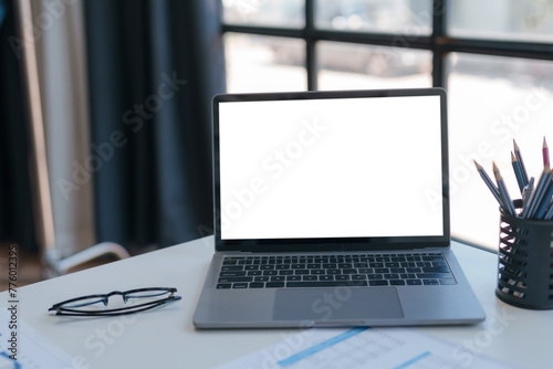 Modern Laptop on Office Desk with Blank Screen