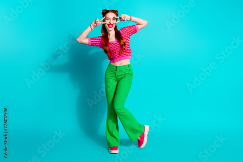 Full length photo of impressed cool lady dressed pink knitted shirt showing two v-signs isolated blue color background