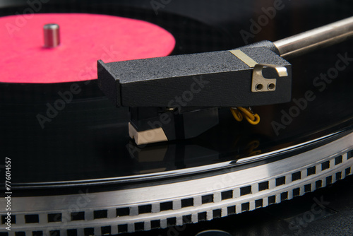 a black vinyl record lies on a turntable for playing music, close-up