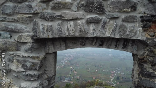 Aerial of the ruins of the medieval Somloi Castle in Hungary on top of a hill on a rainy day photo