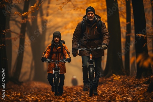 Father and little son having fun riding bicycles together in the picturesque park setting