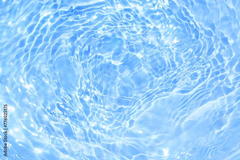Reflection of sun on blue water ripple surface Reflection of sun on blue water ripple surface