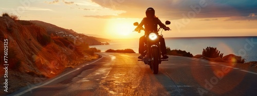 motorcycle rider on a road at sunset panorama, motorcyclist riding along a scenic road at sunset, freedom and adventure concept © id512