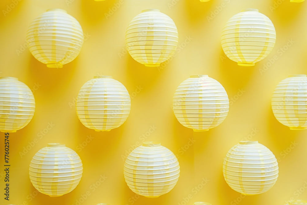 Yellow paper lanterns on a vibrant yellow background with space for text or image, creating a bright and cheerful mood