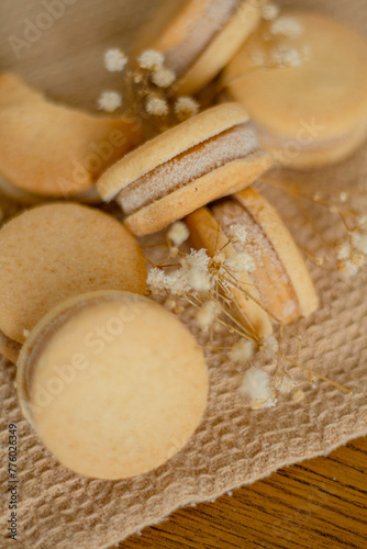 Beige biscuits on wooden background. Minimalist composition.