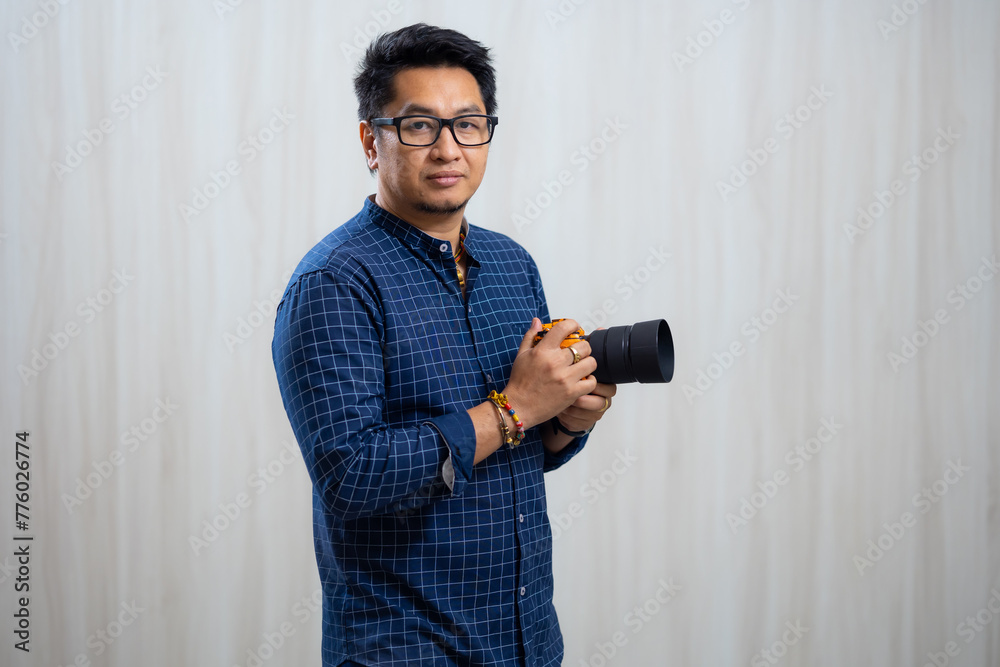 Photographer with camera - Portrait Photographer male shooting photo in shooting studio Photographer with camera - Portrait Photographer male shooting photo in shooting studio