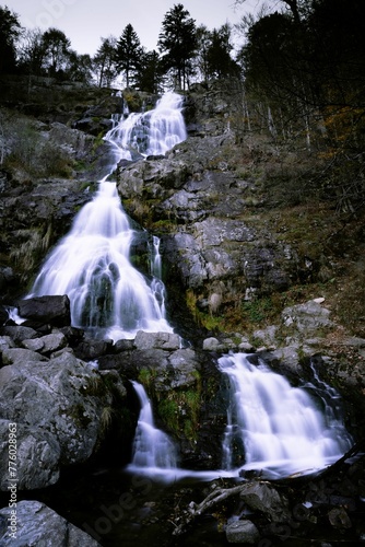 Low-angle view of a water fall on a rocky mount.