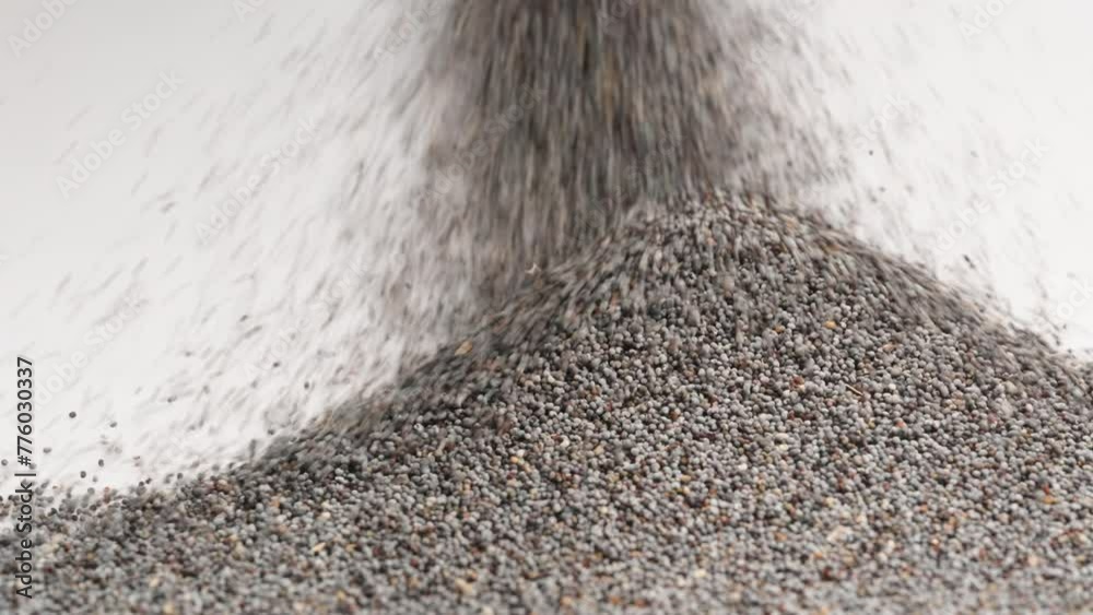A mound of poppy seeds continues to grow, filling up all available space. A mound of poppy seeds continues to grow, filling up all available space.
