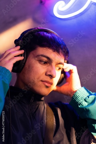 Portrait of a Caucasian (White) male listening to music with headphones