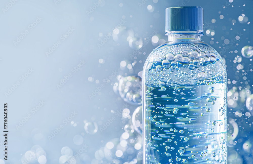 Crystal Clear Plastic Water Bottle Encased in Bubbles with a Blue Cap on a Bright Background Crystal Clear Plastic Water Bottle Encased in Bubbles with a Blue Cap on a Bright Background