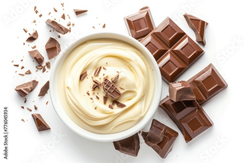 Bowl of melted white chocolate and broken pieces of chocolate bar isolated on white background photo