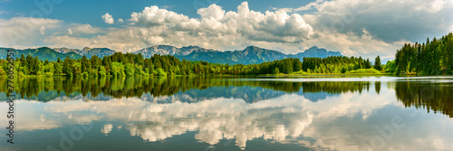 Panoramic photo of rural landscape with reflection in lake in the Allgäu in Bavaria