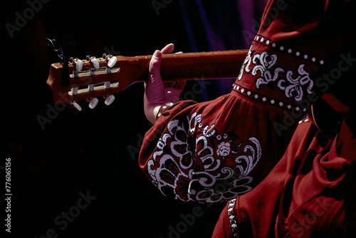  woman's hand on the fretboard of an acoustic guitar
