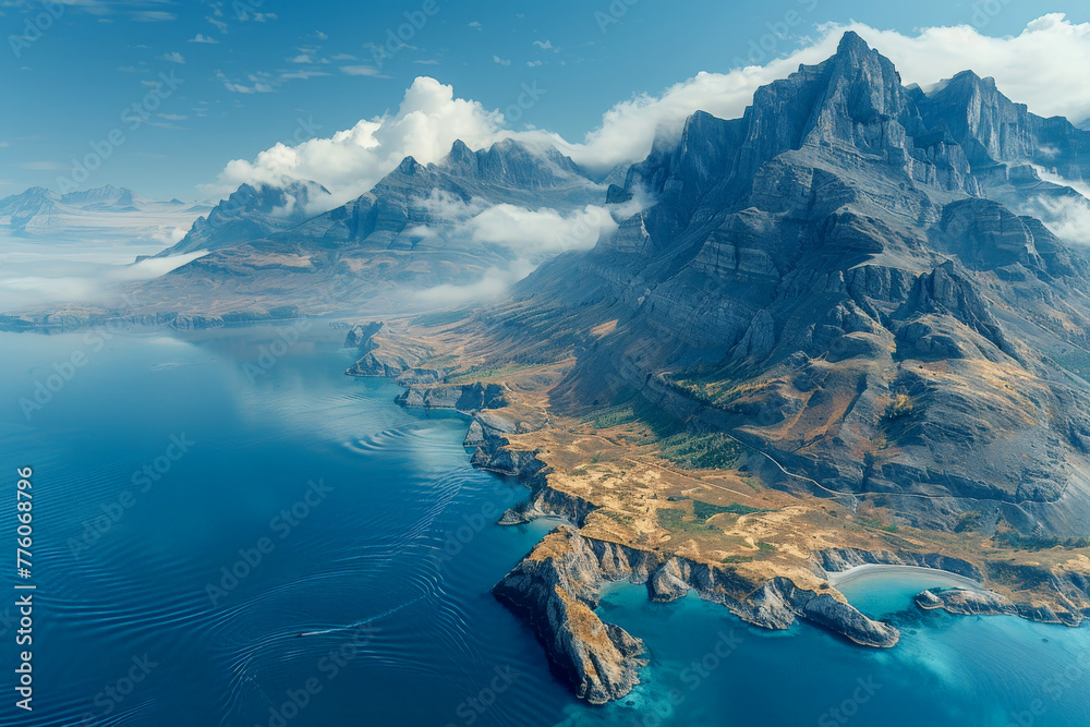 Naklejka premium A breathtaking scenery where majestic mountains meet the tranquil ocean with clouds wrapping the peaks