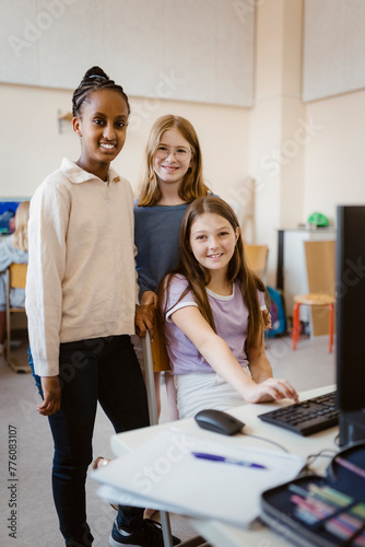 Portrait of multiracial female students in computer class at school