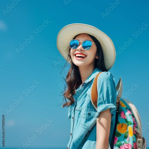 Joyful adventurer in summer attire ready for a holiday excursion against a clear blue sky