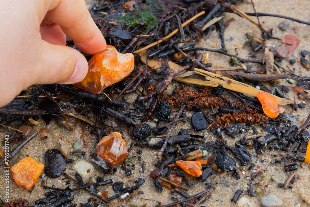 Beautiful pieces of amber in your hand. A glowing wavy piece of amber on your palm. The sunstone. Beautiful pieces of amber in your hand. A glowing wavy piece of amber on your palm. The sunstone.
