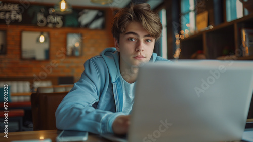 Young man working on laptop, boy freelancer or student with computer in cafe , Generative AI	
