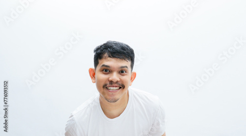 Smile face close up to the camera. An asian man with white t-shirt