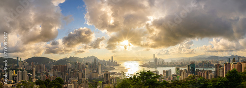 aerial view of Hong Kong skyline and cityscape with sunset. Amazing panorama of highrise buildings and modern towers and sky reflecting in the harbor. Hong Kong island and Kowloon landside. photo