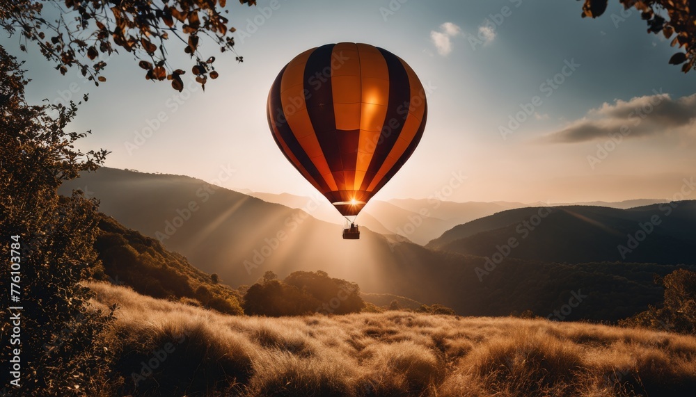 A serene hot air balloon floats over golden hills at sunset, offering a tranquil and breathtaking view from above.