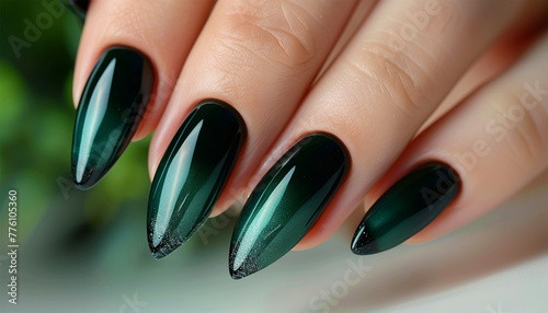 Gel nail extensions dark green. Hand of the girl. Female manicure. Long colored acrylic nails.