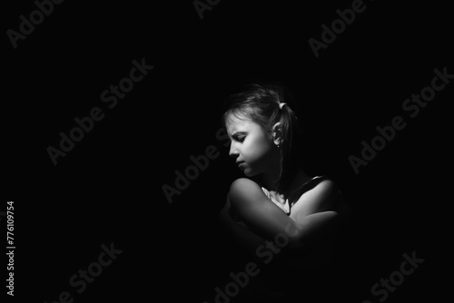 Conceptual image: lost childhood, emotional pain, and children's pain, depression and domestic violence. Portrait of sad and desperate girl. Copy space for text or design.