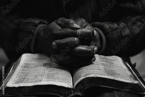 Hands in Prayer over Bible