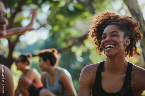 A group of friends laughing and bonding during a outdoor fitness class in the park, surrounded by greenery and fresh air