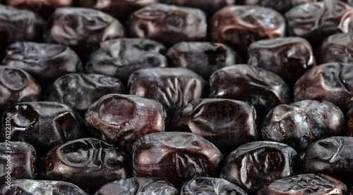 The surface texture of dried dates. Panoramic background with natural oriental sweets. Selective focus.
