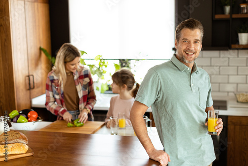 Smiling man holds a glass o...