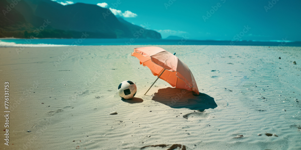 The concept of rest and sports. Parasol with a ball on a sunny beach. Waves and blue sky in the background.