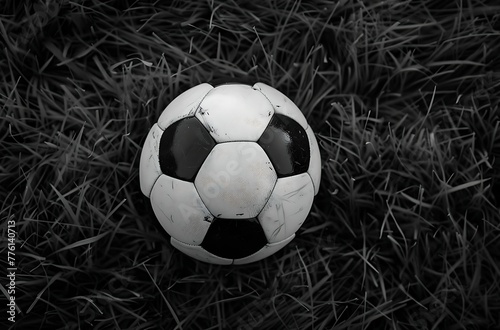 Soccer ball on the ground with a blurred stadium in the background in a low angle shot 