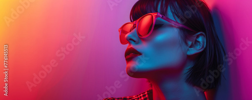 Stylish woman with sunglasses in neon light