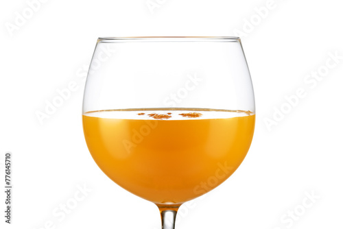 Extreme close up of orange juice in a balloon glass isolated on white background.