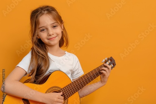 child playing guitar orange background