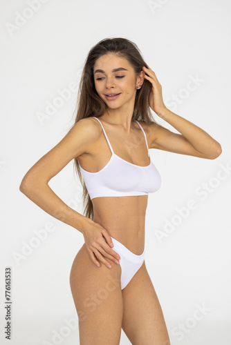 Slim body of a woman in lingerie on the white background