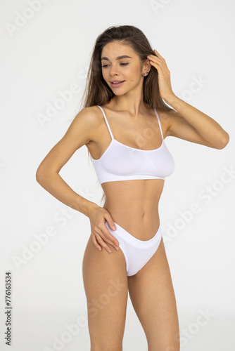 Perfect body in white lingerie on white background. Beauty and body care concept