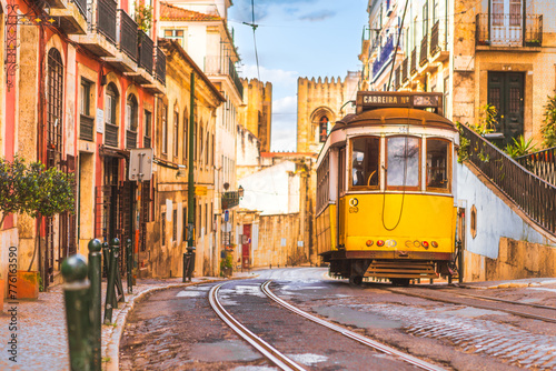 Lisbon city old town and famous yellow tram 28 with Santa Maria cathedral on background. Lisbon, Portugal. 