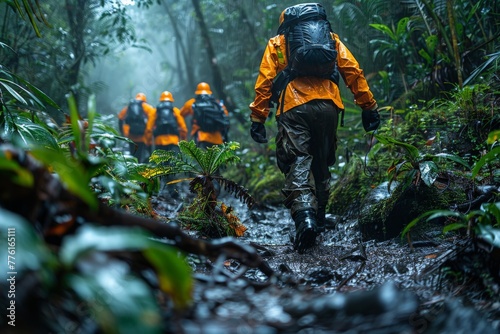 Group of adventurers in bright orange raincoats hiking through a lush, misty jungle trail