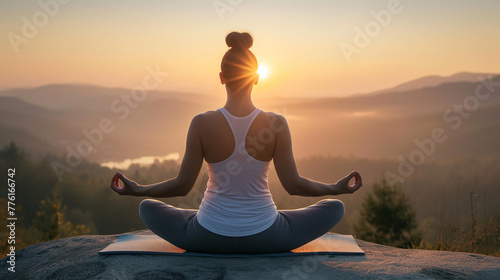 Woman practicing yoga, sitting in lotus position. Serenity, meditation, Zen. Yoga in nature. Yoga practice at sunset.